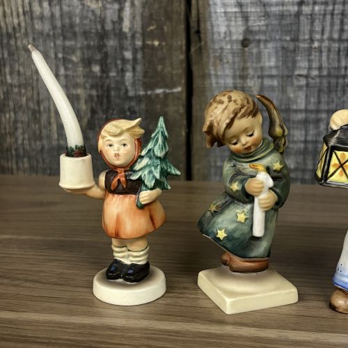 A Set of Five Goebel M.I. Hummel Christmas Themed Ceramic Figurines