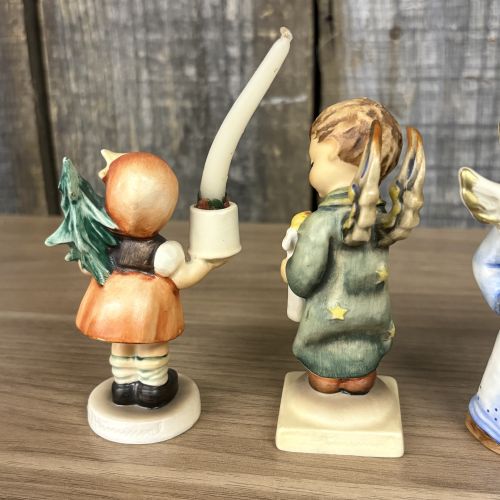 A Set of Five Goebel M.I. Hummel Christmas Themed Ceramic Figurines