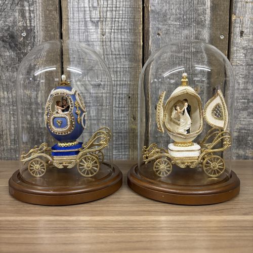 A Pair of Musical Faberge Style Wedding Carriage Egg Figurines with Glass Cloches