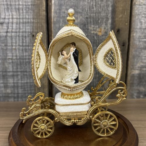 A Pair of Musical Faberge Style Wedding Carriage Egg Figurines with Glass Cloches