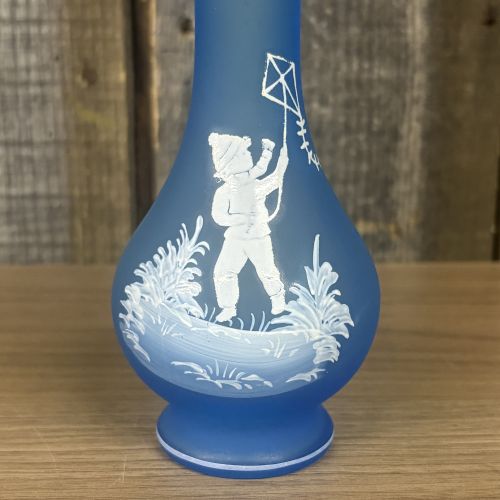 Two Mary Gregory Glass Items Including an Amber Decanter and a Frosted Blue Vase