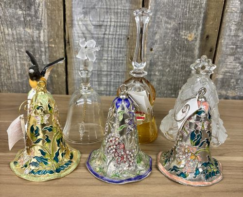 An Assortment of Seven Decorative Porcelain, Glass, and Enameled Metal Bells