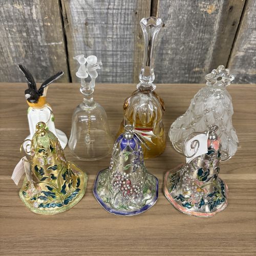 An Assortment of Seven Decorative Porcelain, Glass, and Enameled Metal Bells