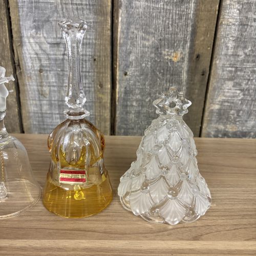 An Assortment of Seven Decorative Porcelain, Glass, and Enameled Metal Bells