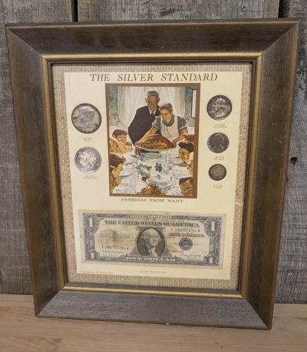 A 1974 Kennedy Mint The Silver Standard Framed Collection of US Coins and Currency