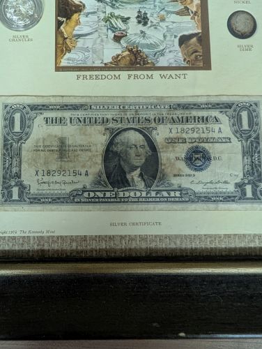 A 1974 Kennedy Mint The Silver Standard Framed Collection of US Coins and Currency