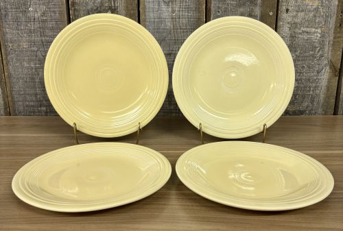 A Set of Four Homer Laughlin Fiesta Yellow Dinner Plates