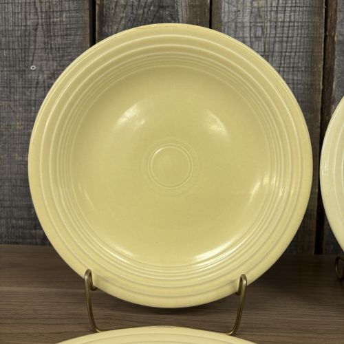 A Set of Four Homer Laughlin Fiesta Yellow Dinner Plates