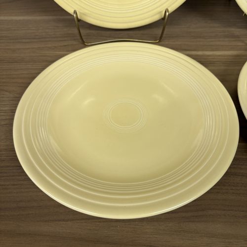 A Set of Four Homer Laughlin Fiesta Yellow Dinner Plates