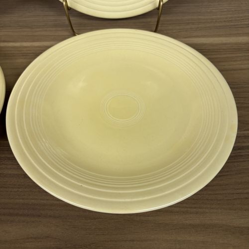 A Set of Four Homer Laughlin Fiesta Yellow Dinner Plates