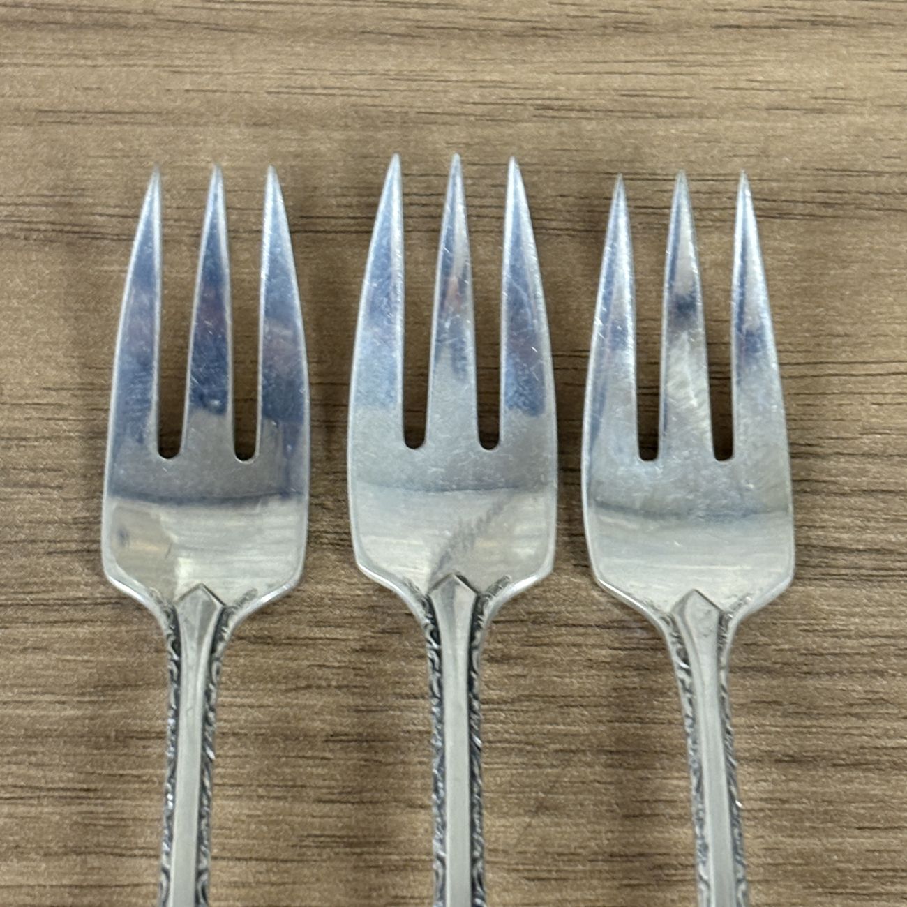 A Trio of Towle Sterling Silver Cocktail Forks in the Candlelight Pattern