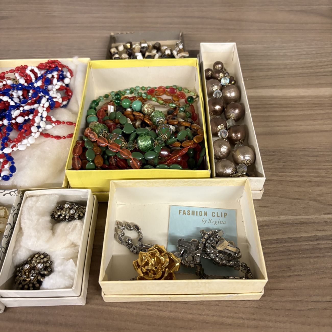 An Assortment of Vintage Costume Jewelry Including Fashion Clip by Regina and Venetian Style Glass Beads