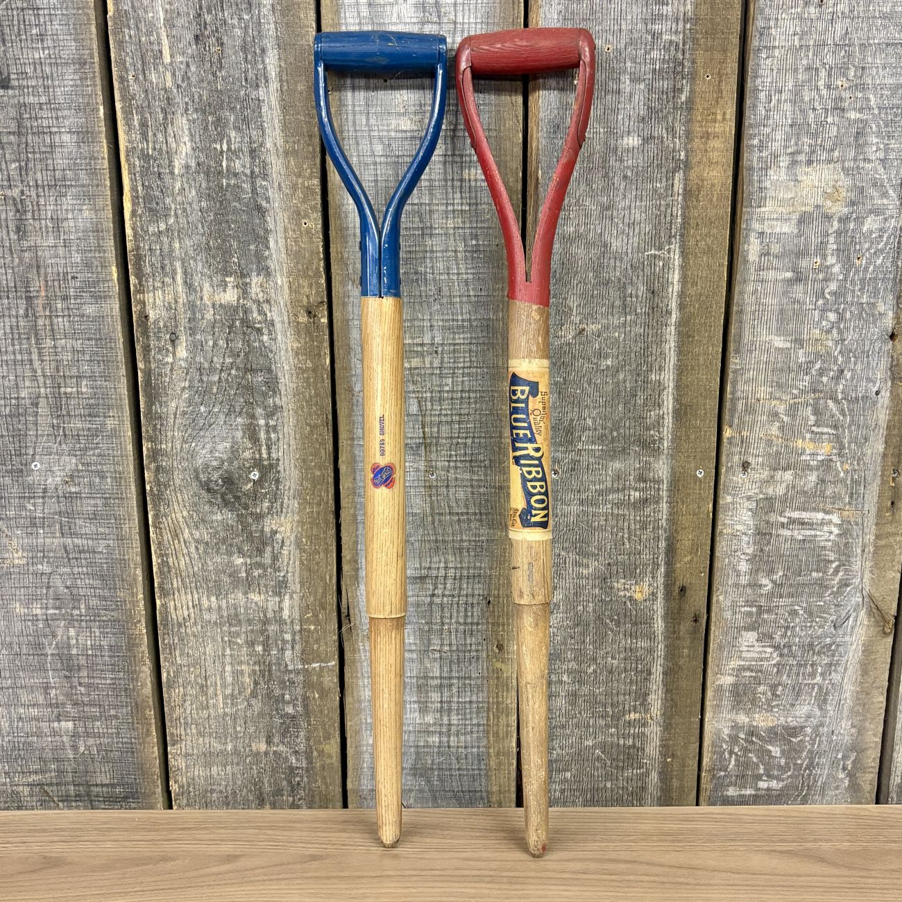 A Pair of Vintage Belknap Blue Grass and Shapleigh Blue Ribbon D-Handle Tool Shafts