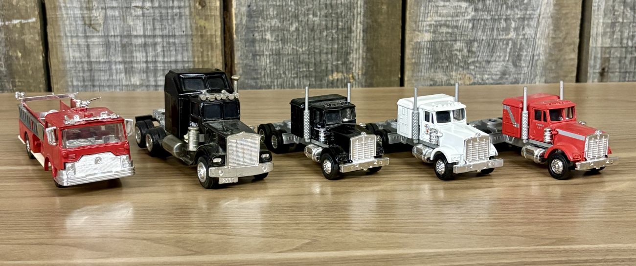 A Collection of Five Vintage Semi-Tractor Cabs and Fire Engine by Lionel, GATA, and Szetoy