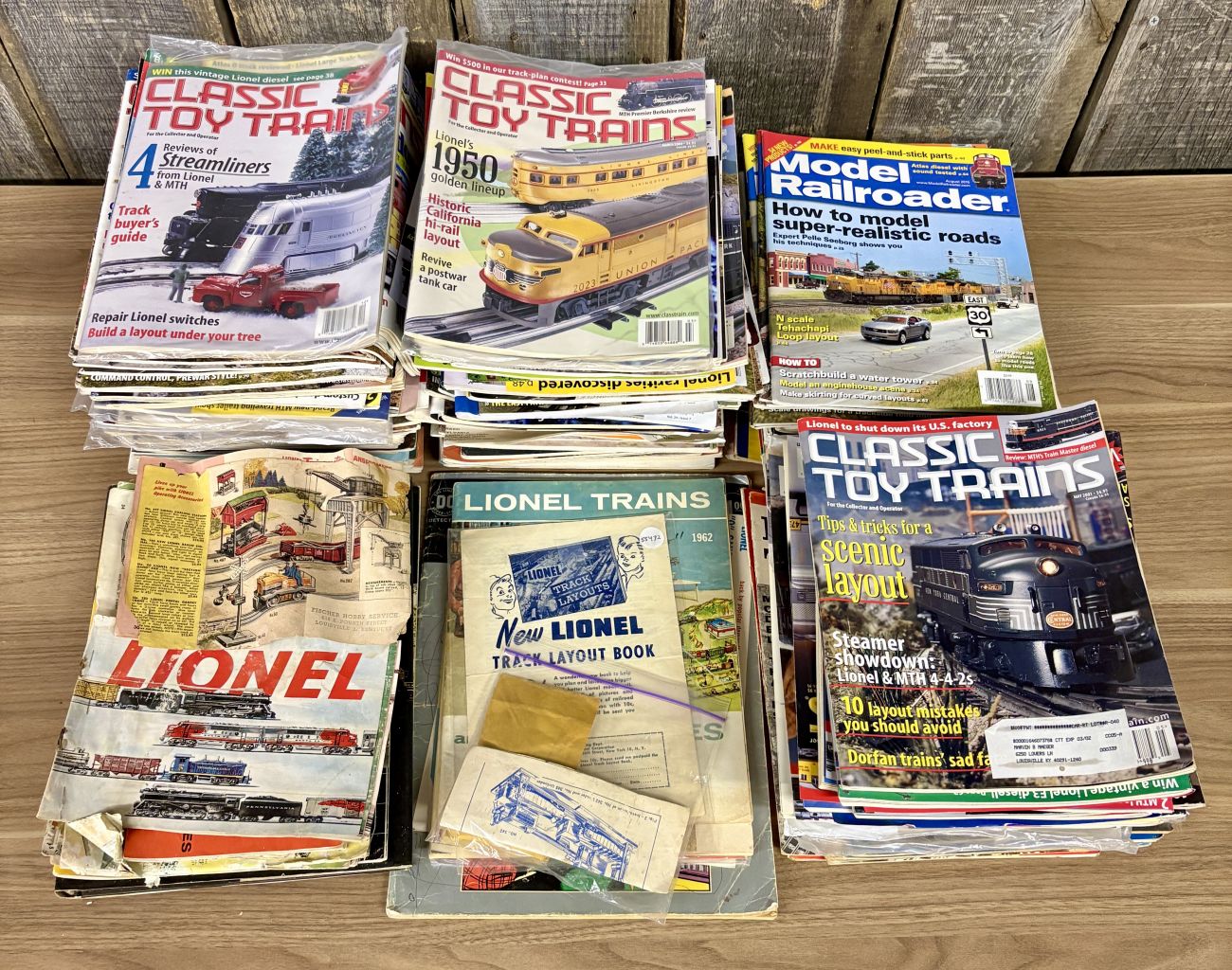 A Collection of Classic Toy Trains and Model Railroader Magazines with Vintage Lionel Ephemera
