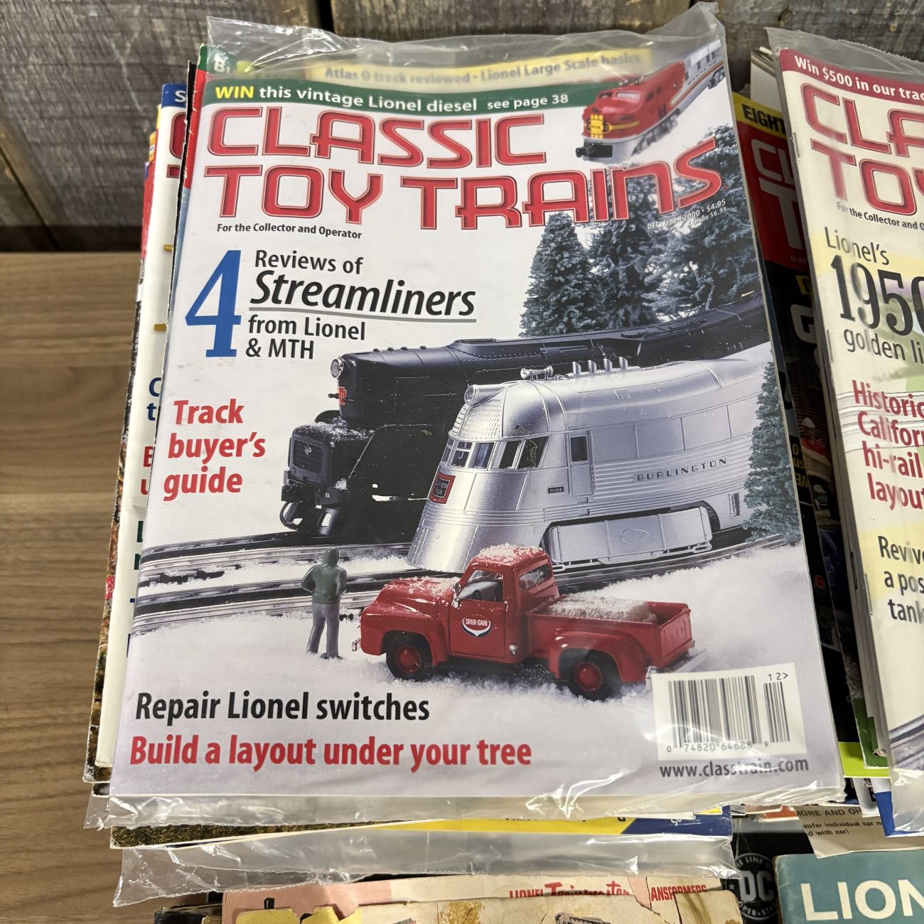 A Collection of Classic Toy Trains and Model Railroader Magazines with Vintage Lionel Ephemera