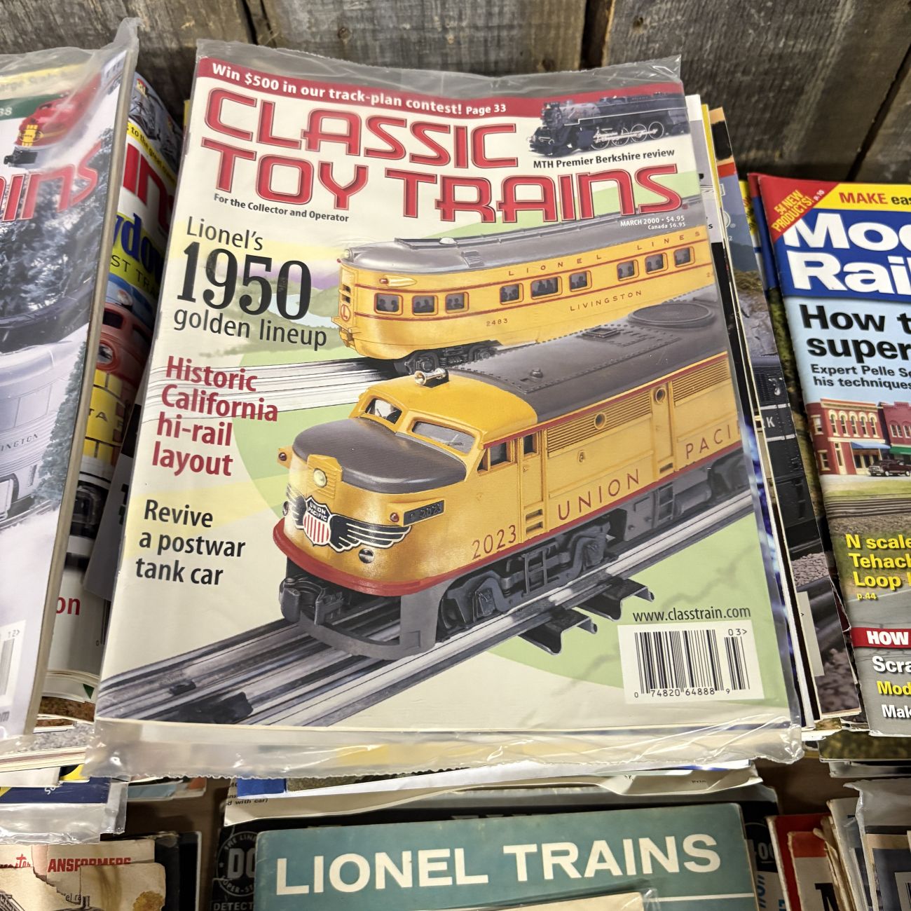 A Collection of Classic Toy Trains and Model Railroader Magazines with Vintage Lionel Ephemera