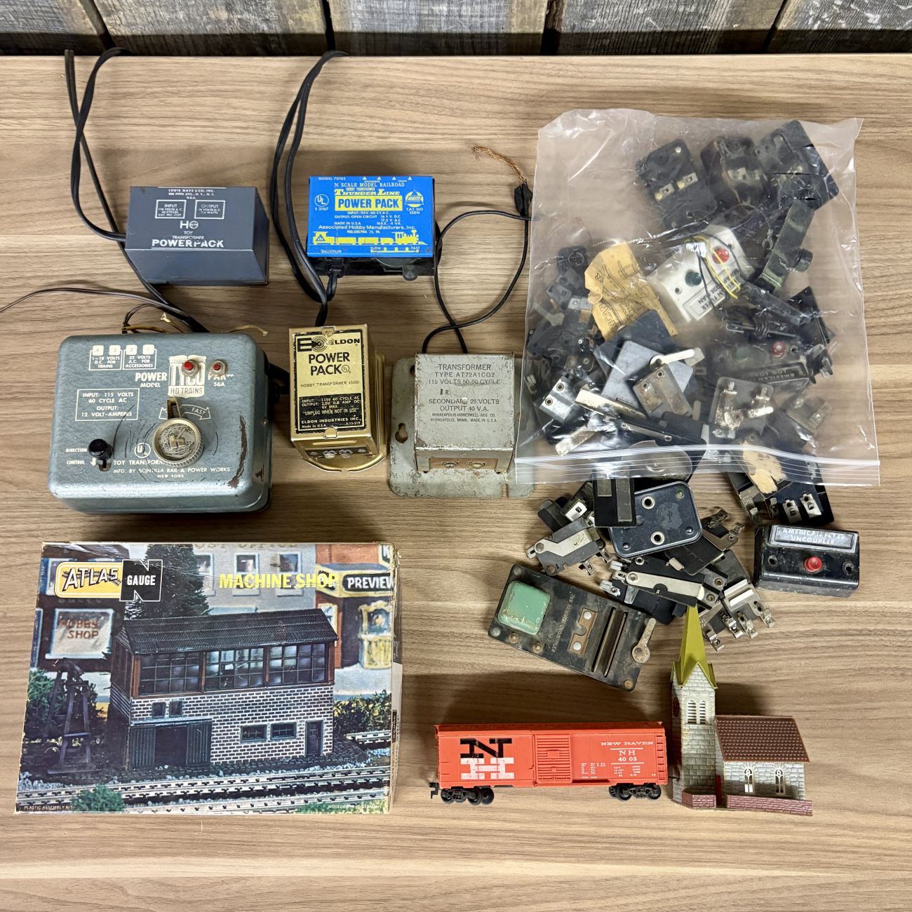 An Assortment of Vintage HO and N Scale Model Train Transformers, Rolling Stock, and Track Accessories