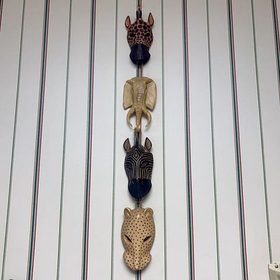 A Set of Four Hand-Carved and Painted Wood African Animal Masks on a Vertical Hanging Cord. A 