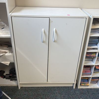 White Two-Door Utility Storage Cabinet. A floor-standing utility storage cabinet constructed 
