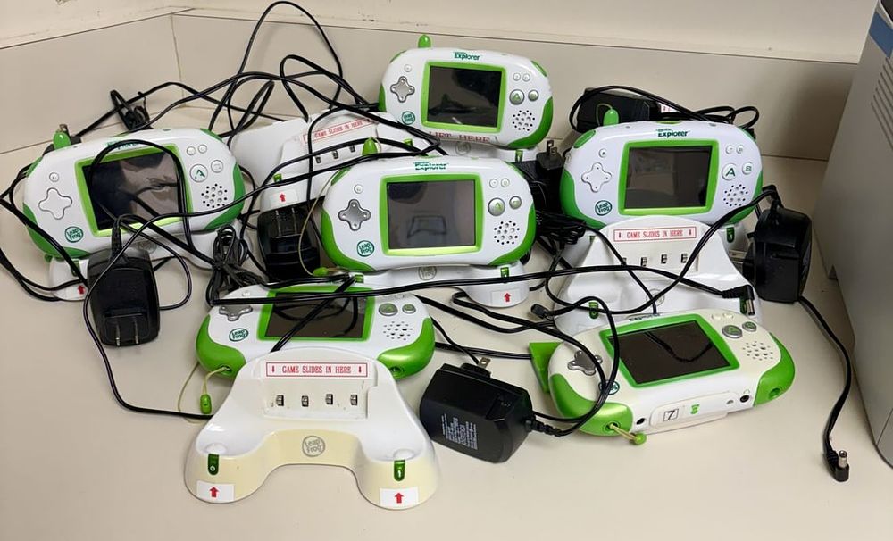 Lot 459: Six LeapFrog Leapster Explorer Handheld Learning Systems with Charging Docks and Adapters