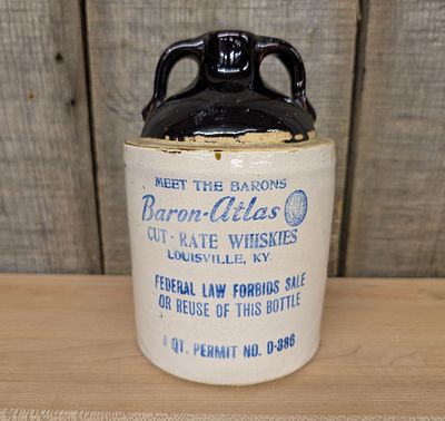 Baron-Atlas Cut-Rate Whiskies Two-Handled Stoneware Jug. This cylindrical stoneware whiskey jug 
