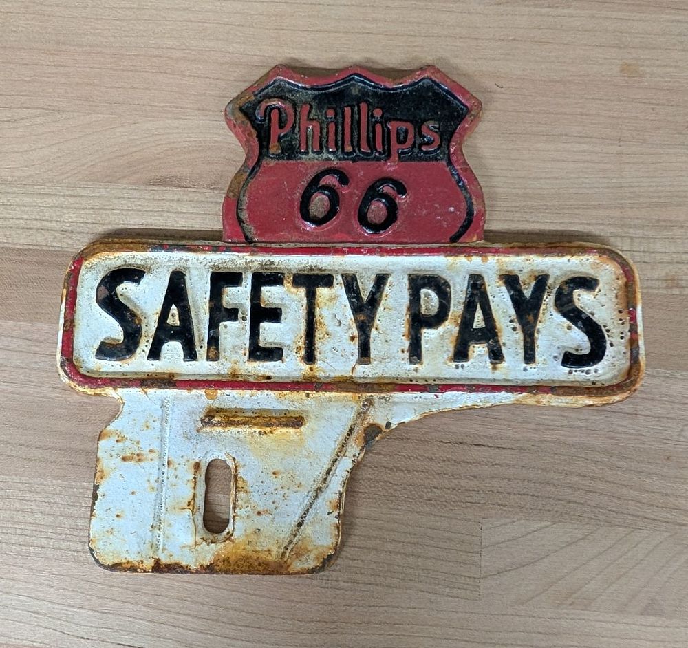 Lot 384: Phillips 66 Cast Iron Safety Pays License Plate Topper