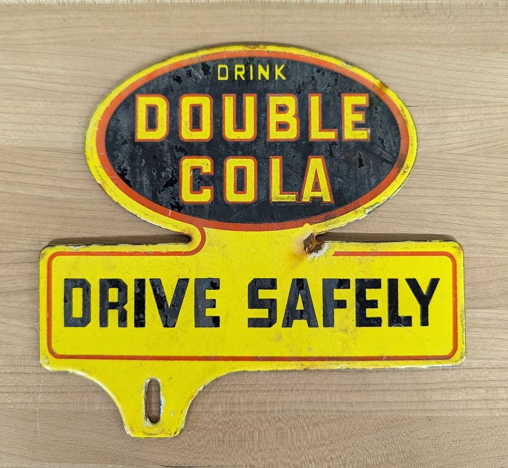Lot 391: Vintage Enameled Metal Double Cola Drive Safely License Plate Topper