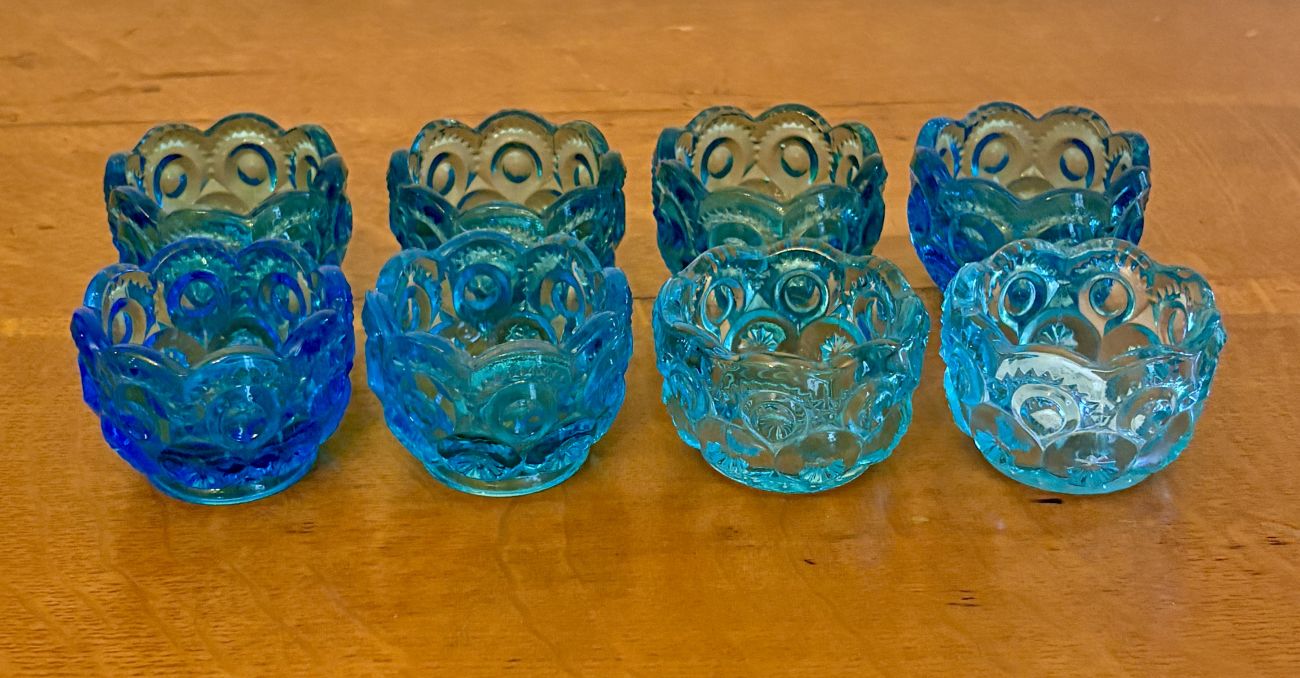 A Set of Eight Moon and Star Pattern Blue Pressed Glass Salt Cellars