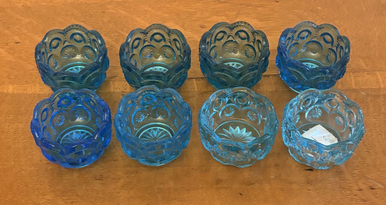 A Set of Eight Moon and Star Pattern Blue Pressed Glass Salt Cellars