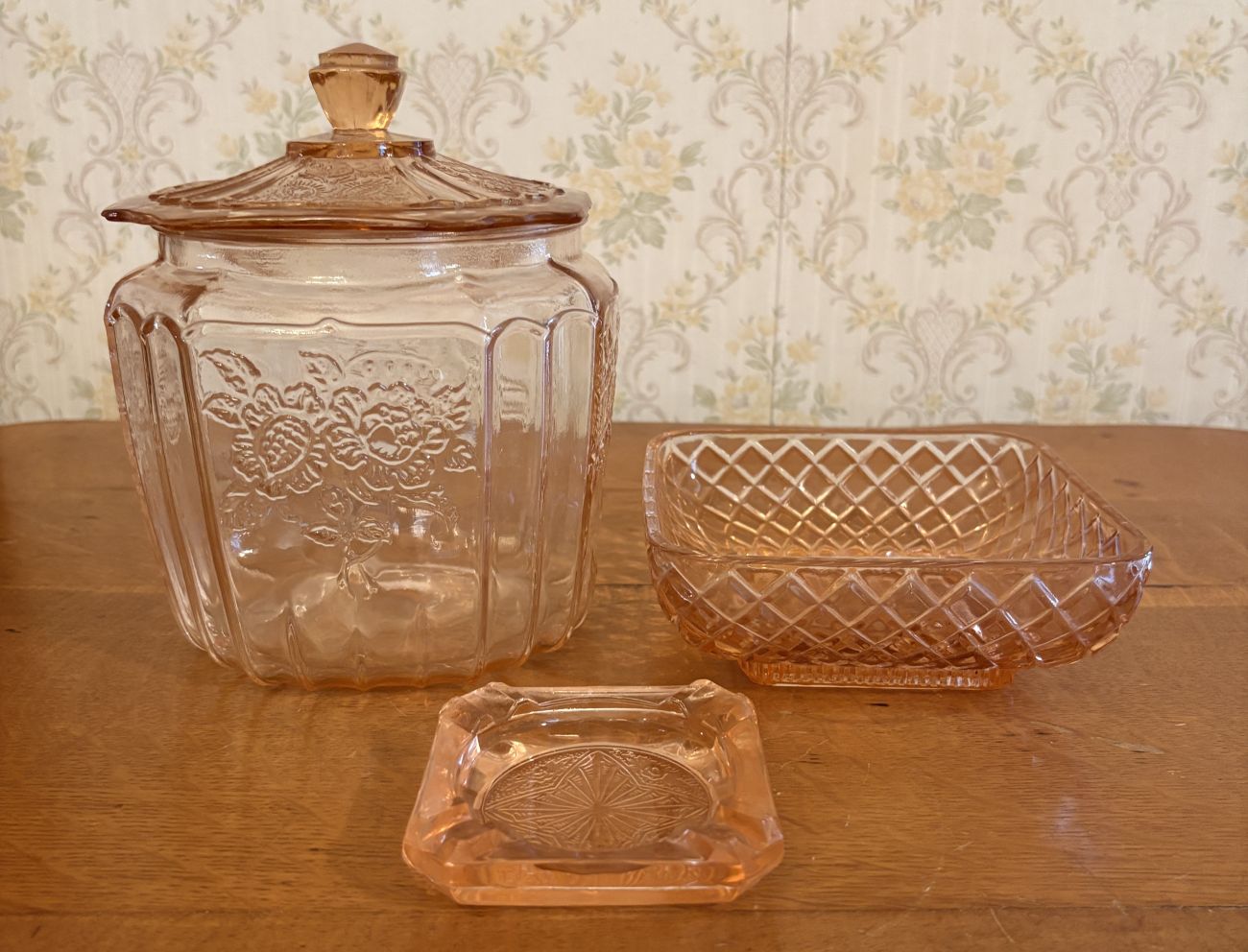 Three Pieces of Pink Depression Glass Including a Sunflower Pattern Cookie Jar