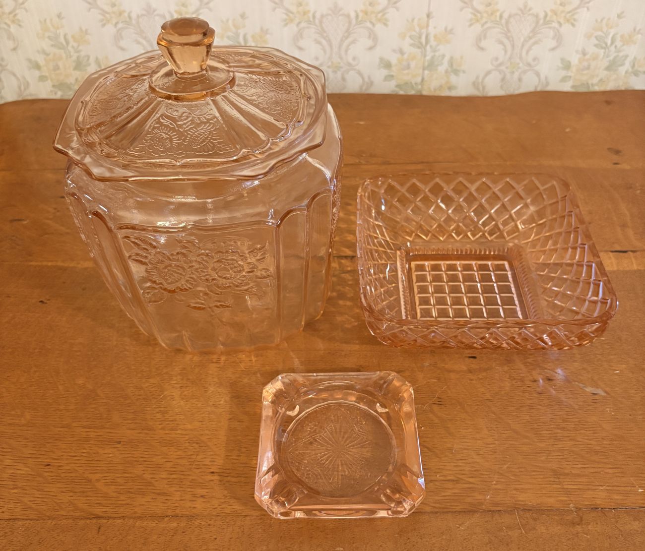 Three Pieces of Pink Depression Glass Including a Sunflower Pattern Cookie Jar