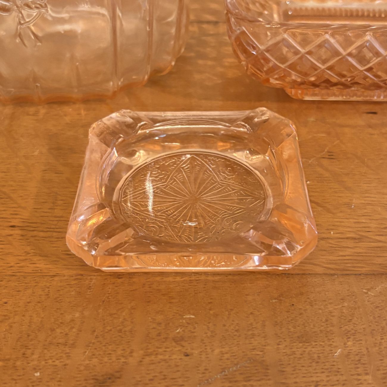Three Pieces of Pink Depression Glass Including a Sunflower Pattern Cookie Jar