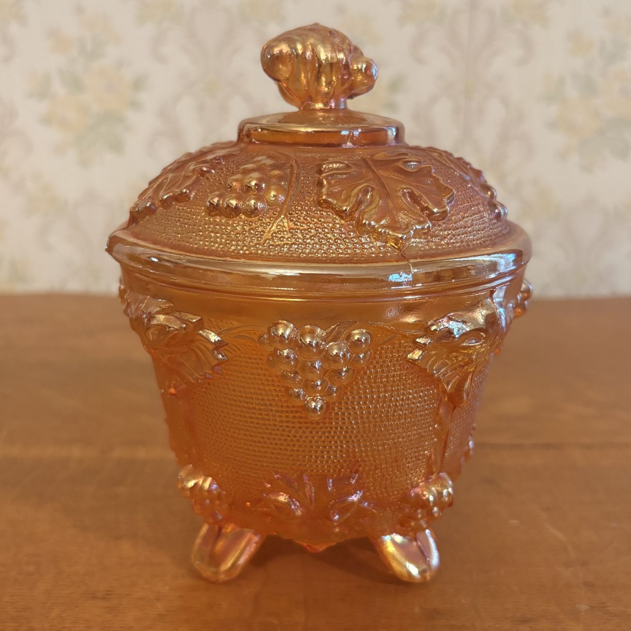 Footed Marigold Carnival Glass Covered Sugar Bowl in Grape and Cable Pattern