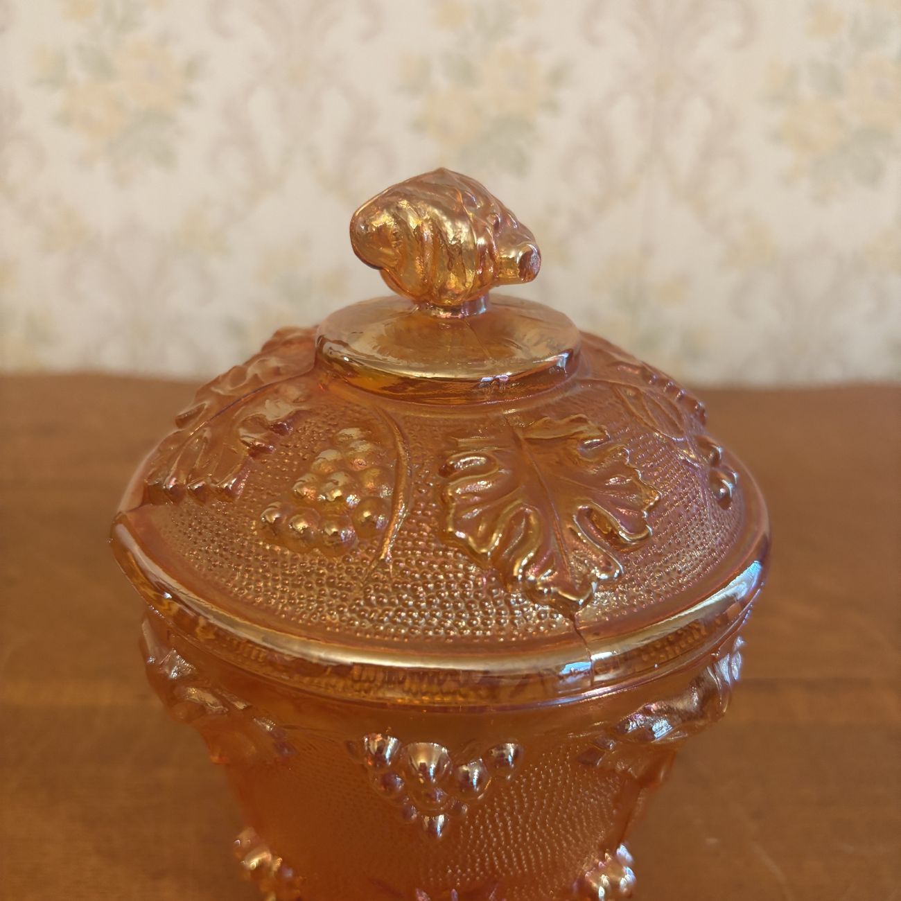 Footed Marigold Carnival Glass Covered Sugar Bowl in Grape and Cable Pattern