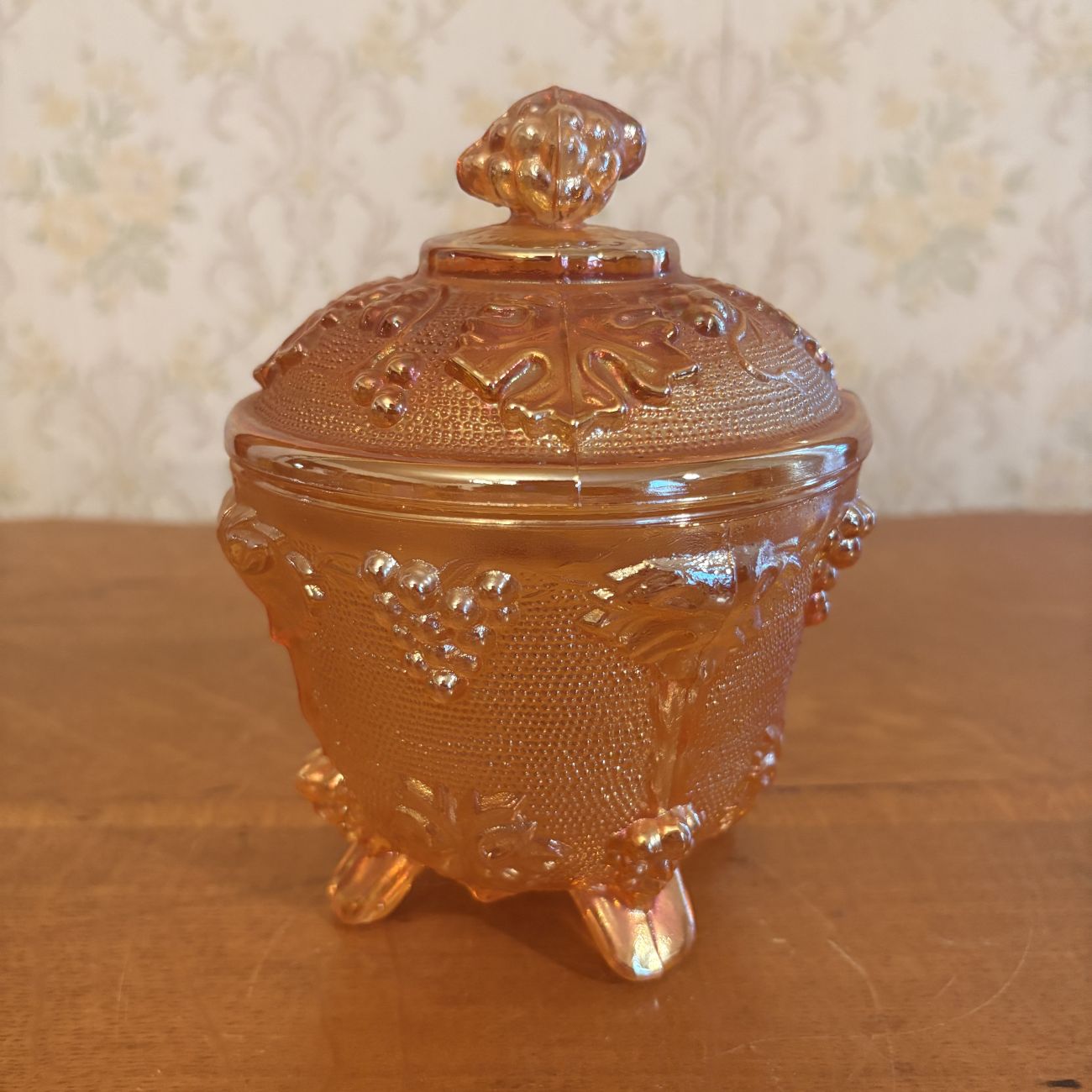 Footed Marigold Carnival Glass Covered Sugar Bowl in Grape and Cable Pattern