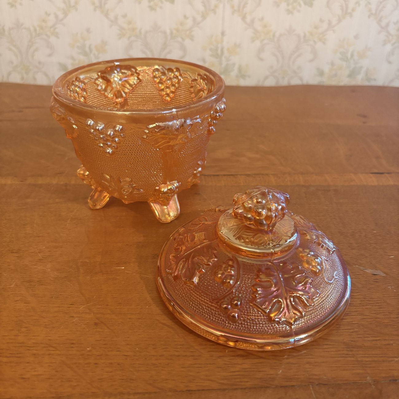 Footed Marigold Carnival Glass Covered Sugar Bowl in Grape and Cable Pattern