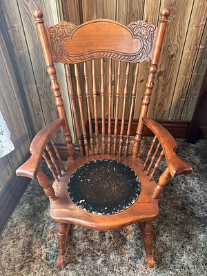 American Antique Carved Oak Press-Back Rocking Chair with Embossed Seat. An American antique 