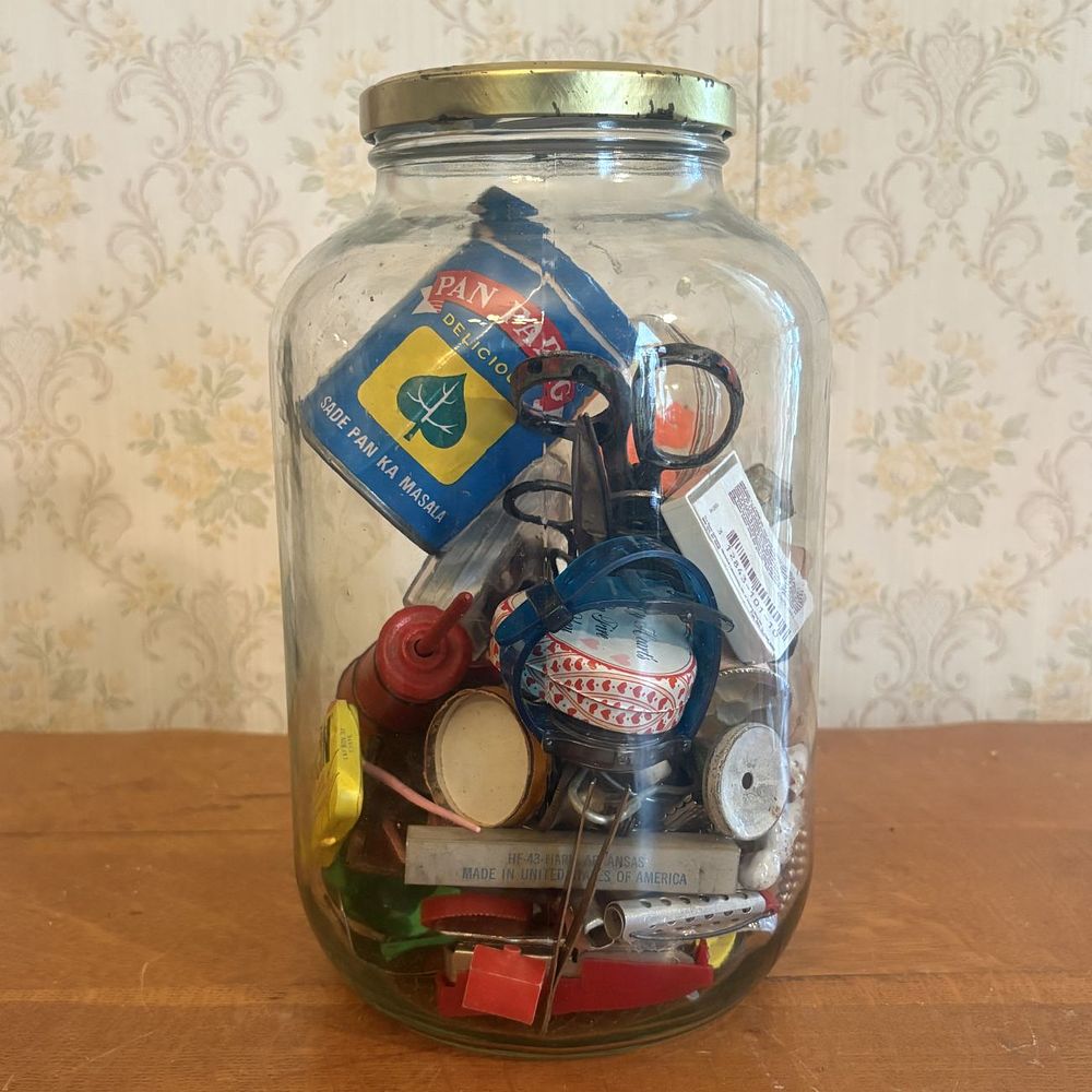 Lot 268: Collection of Vintage Advertising Tins, Antique Doll Limbs, and Miscellaneous Curiosities in Large Glass Jar