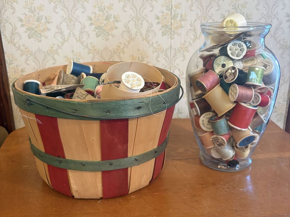 Lot 288: A Large Collection of Vintage Sewing Notions and Thread Spools with Slat Basket and Glass Vase