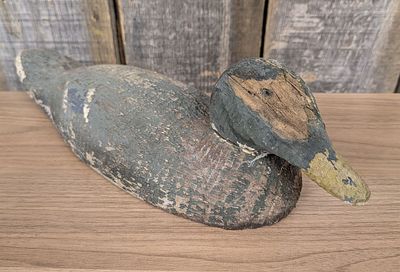 Antique Carved Wood Duck Decoy with Weathered Painted Surface. A solid wood hand-carved duck 