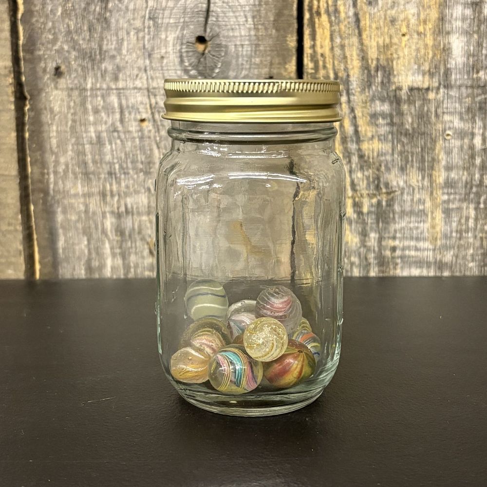 Lot 309: A Collection of Antique and Vintage Glass Latticinio and Swirl Marbles in a Glass Jar