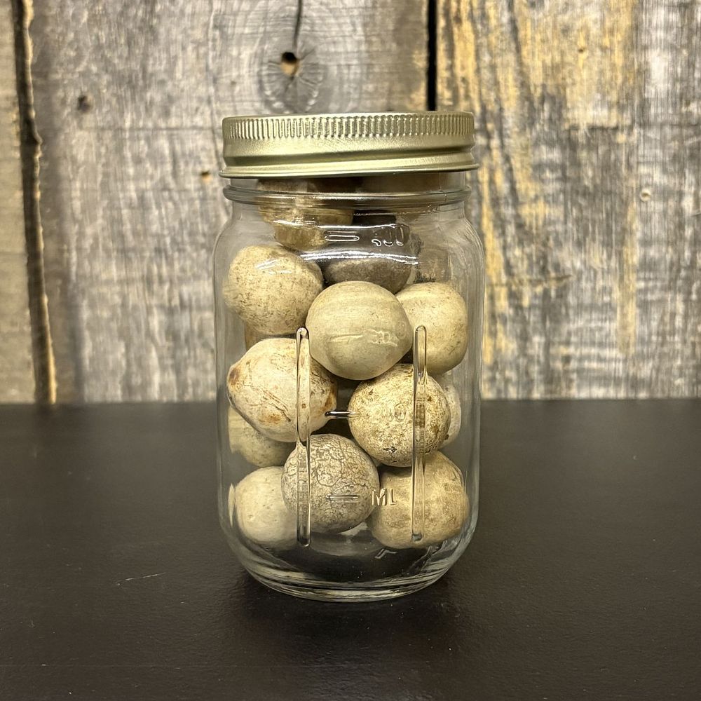 Lot 311: A Collection of Antique Clay Marbles in a Glass Storage Jar