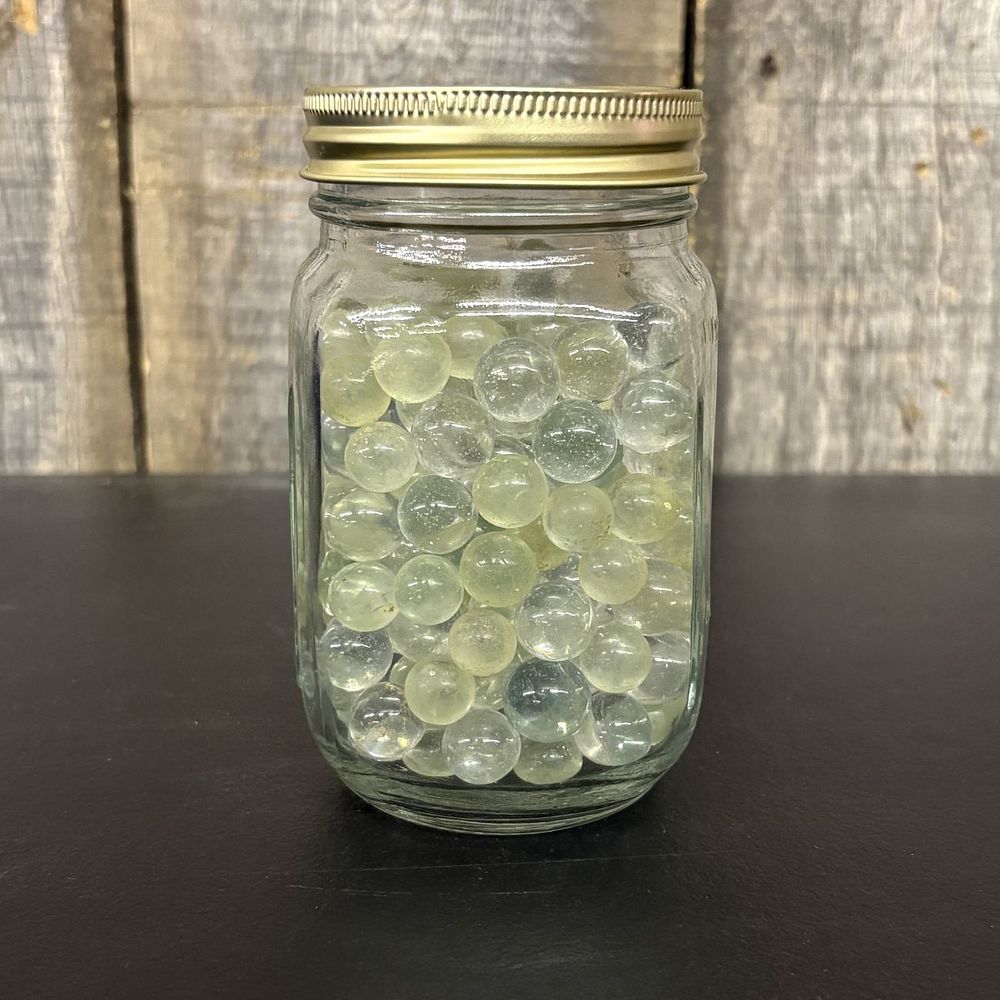 Lot 315: A Collection of Vintage Glass Marbles in a Graduated Canning Jar