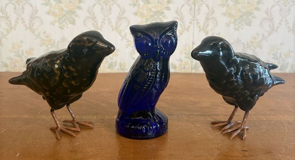 Lot 318: A Trio of Avian Figurines Including a Cobalt Blue Glass Owl and a Pair of Ceramic Crows
