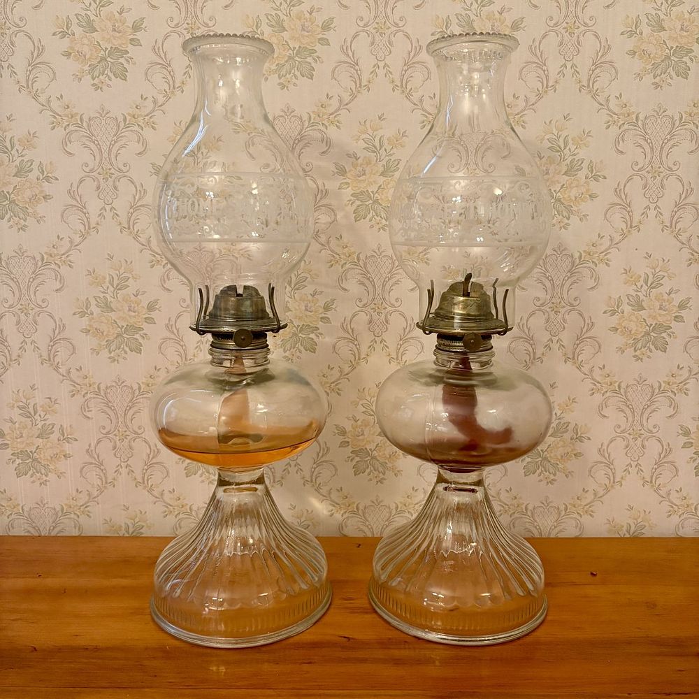 Lot 329: A Pair of Clear Glass Oil Lamps with Home Sweet Home Etched Chimneys