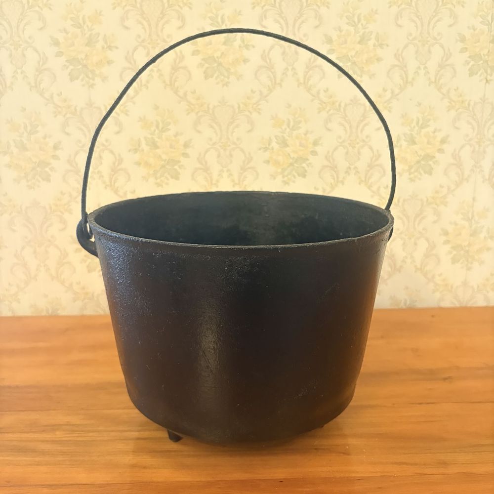 Lot 365: Antique Three Legged Cast Iron Pot with Bail Handle
