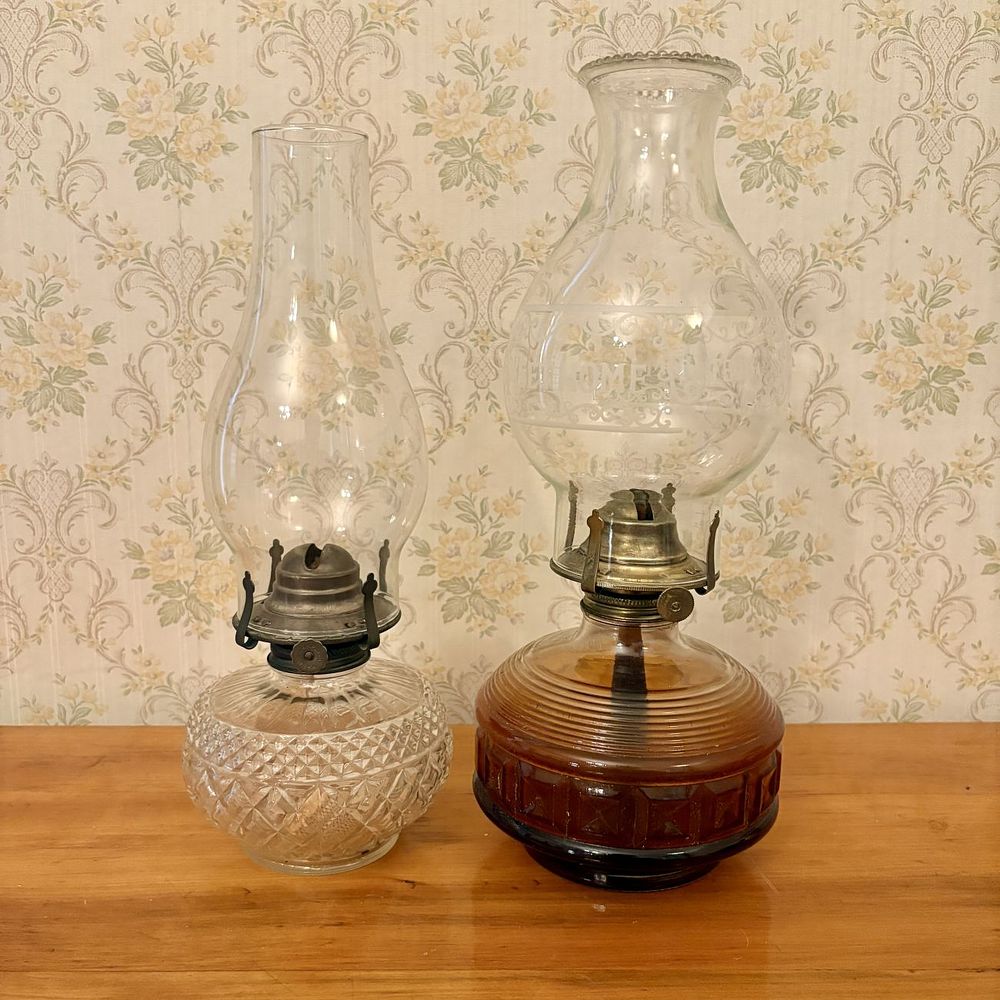 Lot 391: Two Glass Oil Lamps Including One Amber Pressed Glass and One Clear Patterned Glass