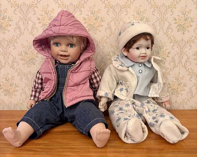 A Pair of Limited Edition Cathay Collection Porcelain Headed Dolls. This pair of collectible 