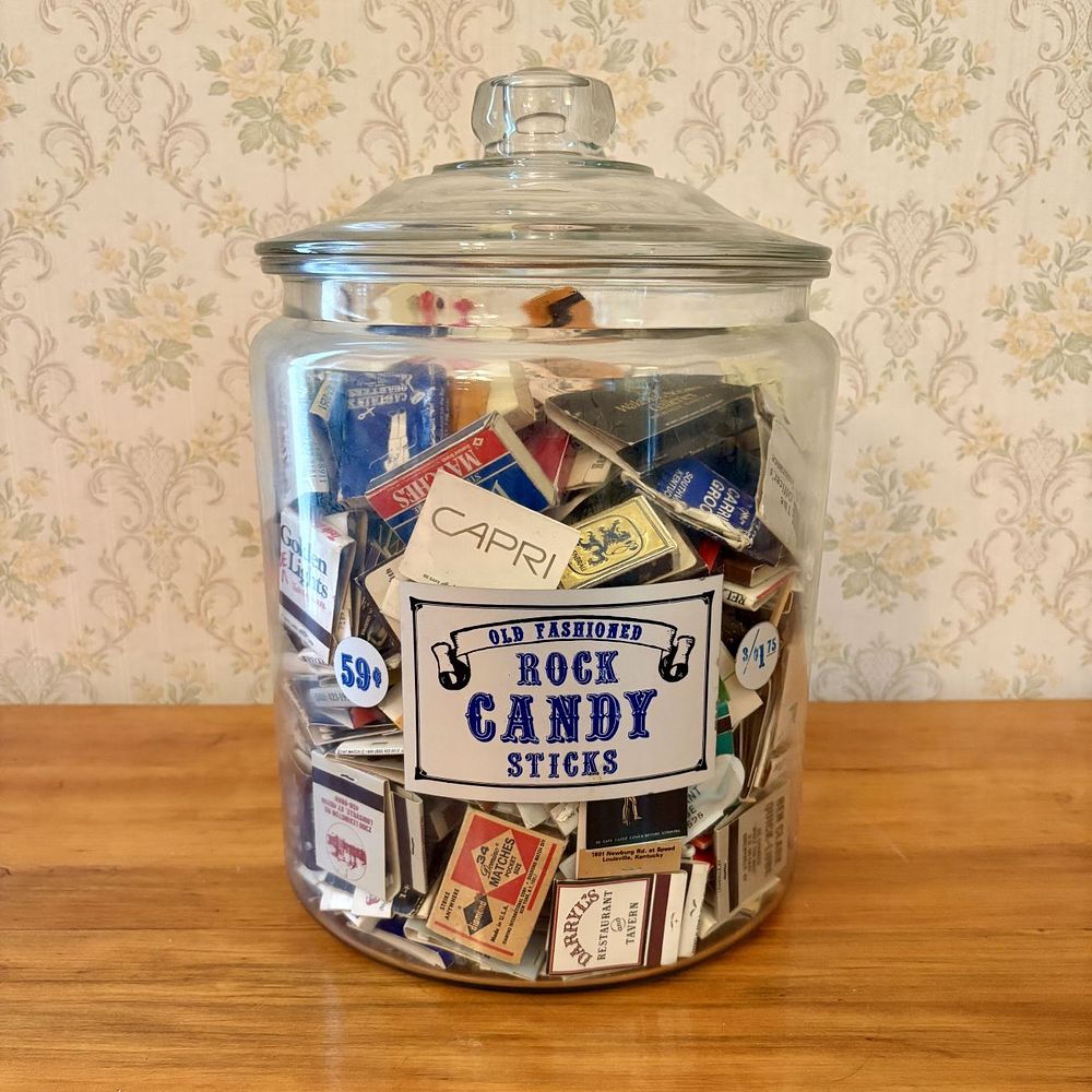Lot 428: A Collection of Vintage Advertising Matchbooks and Matchboxes in a Glass Rock Candy Apothecary Jar
